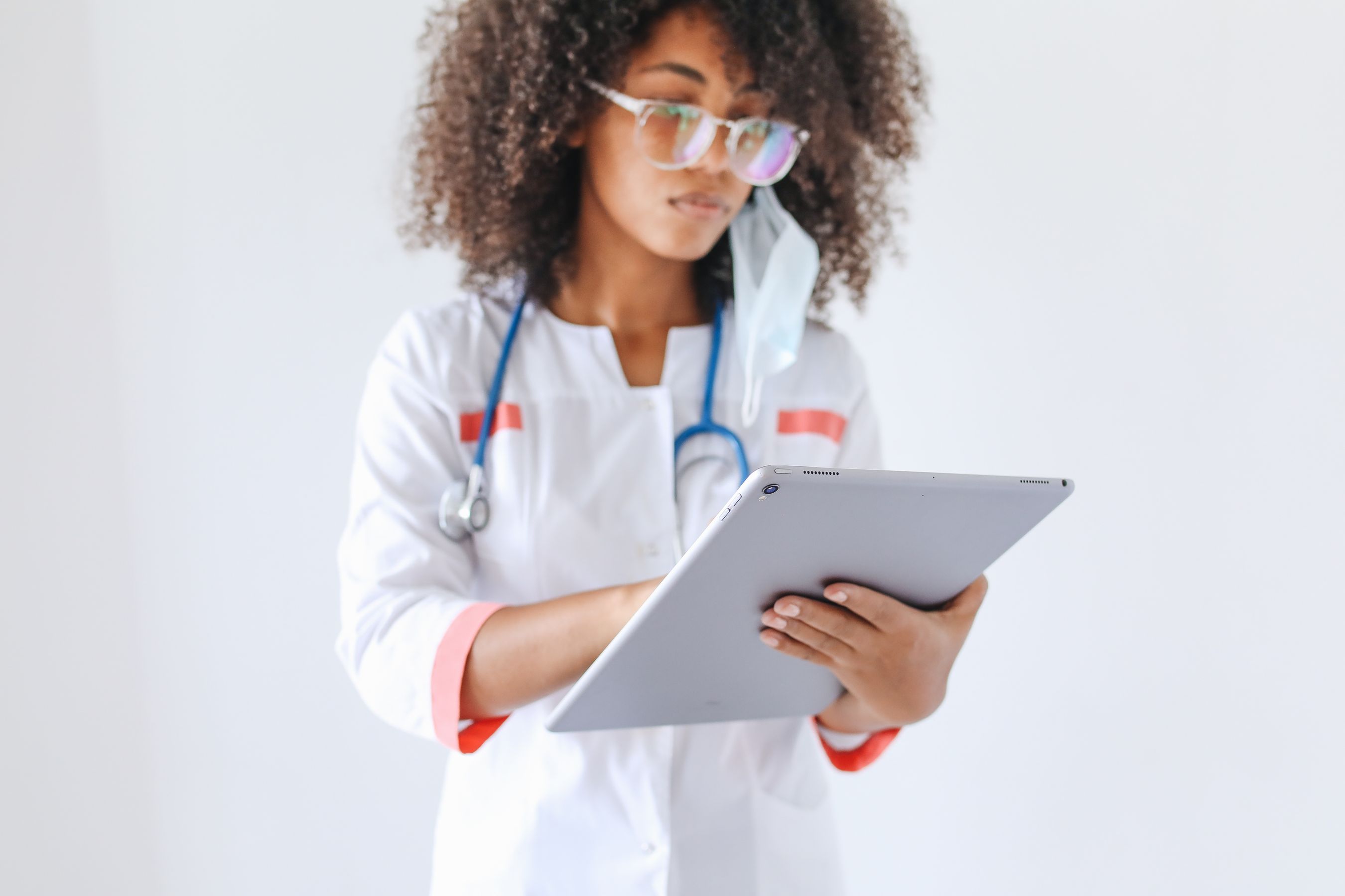 Clinician completing a digital form on a tablet at the point of care